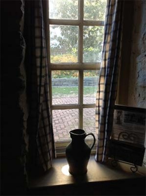pitcher in window of stone house in Georgetown