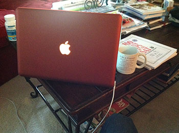 MacBook with terracotta case